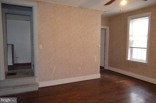 unfurnished room with ceiling fan and dark hardwood / wood-style flooring