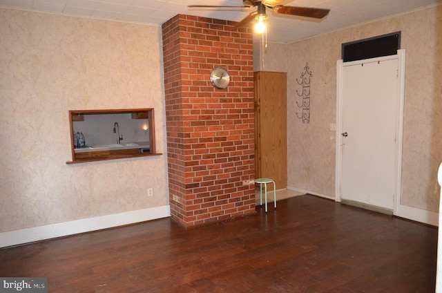 interior space featuring dark hardwood / wood-style flooring, ceiling fan, and sink