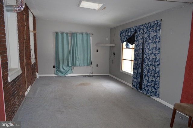 carpeted spare room with a skylight