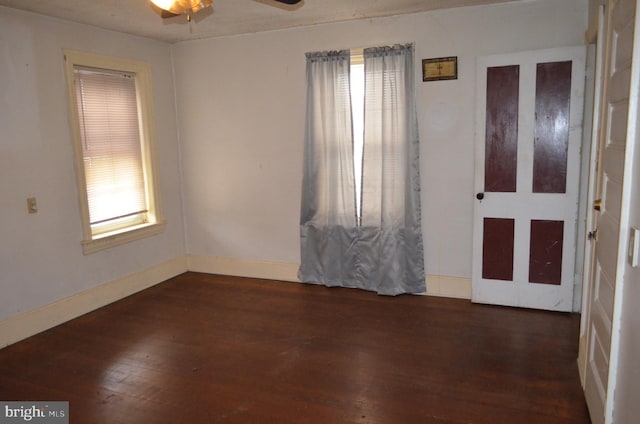 empty room featuring ceiling fan and dark hardwood / wood-style flooring