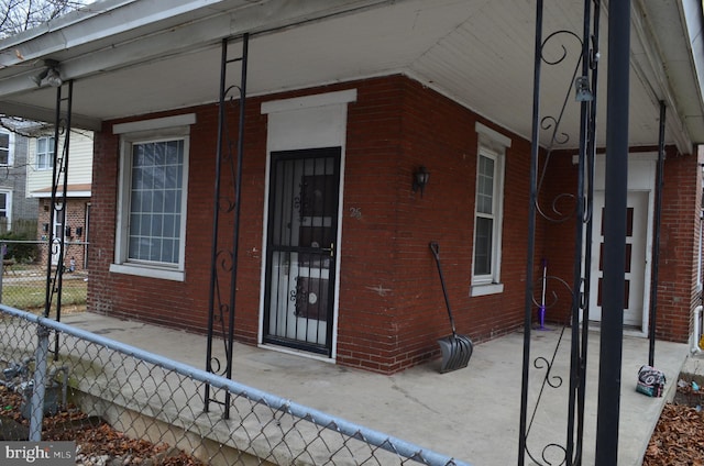 view of exterior entry with covered porch