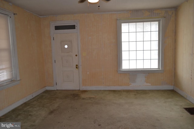 carpeted foyer entrance with ceiling fan