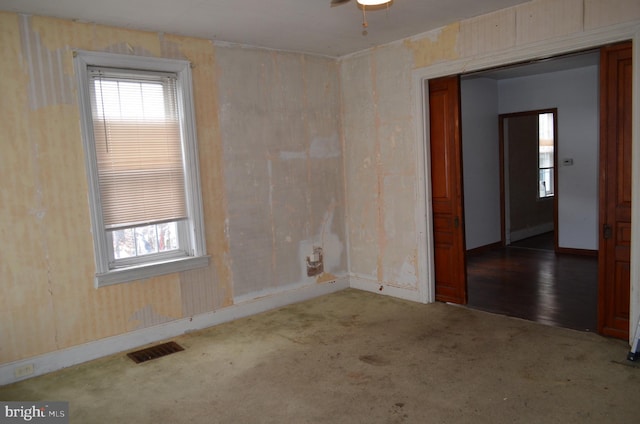 spare room with ceiling fan and carpet