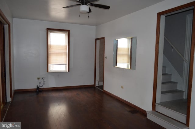 unfurnished room with ceiling fan and dark wood-type flooring