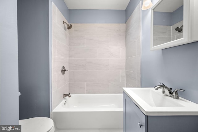 full bathroom with toilet, vanity, and tiled shower / bath