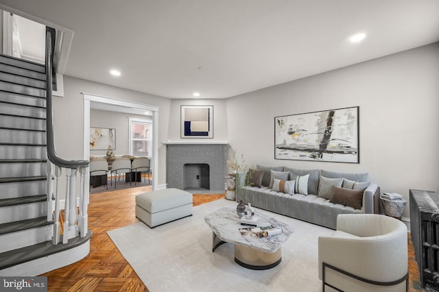 living room with a fireplace and parquet flooring