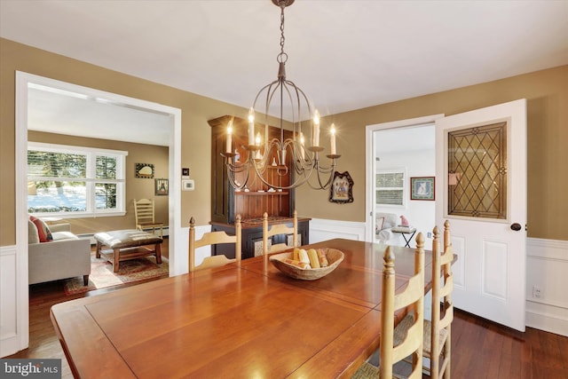 dining room featuring dark hardwood / wood-style floors and an inviting chandelier