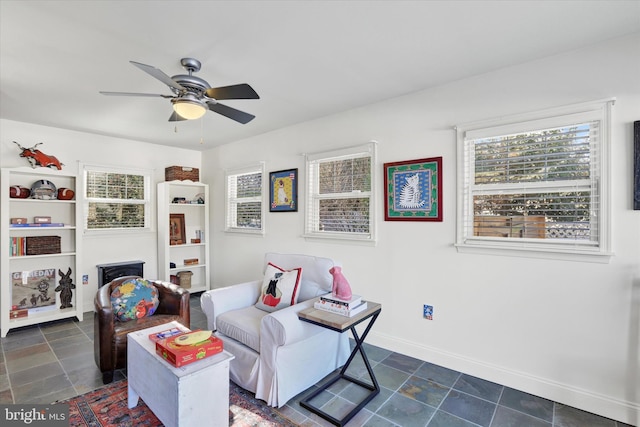 sitting room featuring ceiling fan