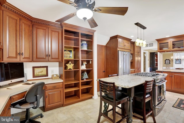 kitchen with a kitchen breakfast bar, light stone counters, high end appliances, a kitchen island, and hanging light fixtures