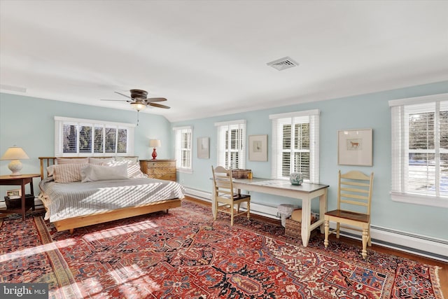 bedroom featuring ceiling fan, lofted ceiling, and hardwood / wood-style flooring