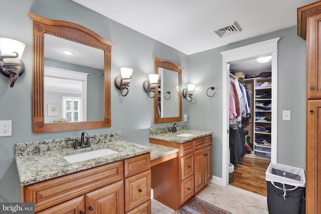 bathroom featuring tile patterned flooring and vanity