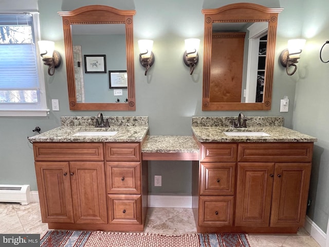 bathroom with vanity and a baseboard heating unit