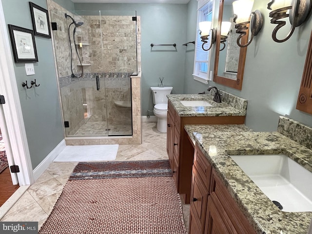 bathroom with vanity, toilet, and a shower with shower door