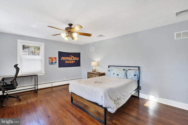 bedroom with ceiling fan, dark hardwood / wood-style flooring, and baseboard heating