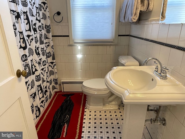 bathroom with a wealth of natural light, a shower with curtain, a baseboard radiator, tile walls, and toilet