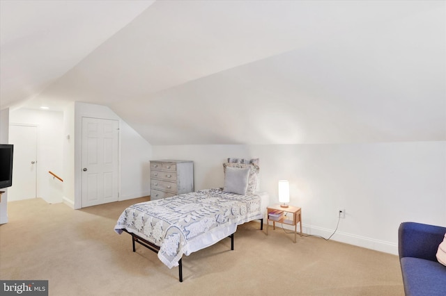 carpeted bedroom with lofted ceiling