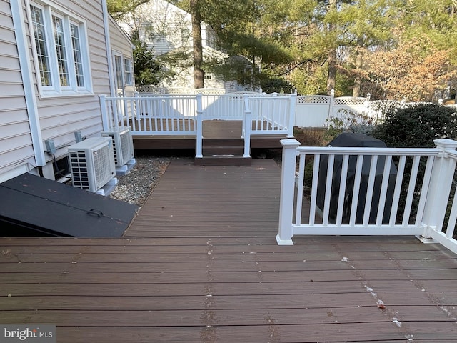 wooden terrace featuring ac unit