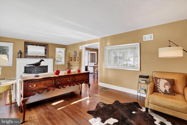 office area featuring a fireplace and hardwood / wood-style floors