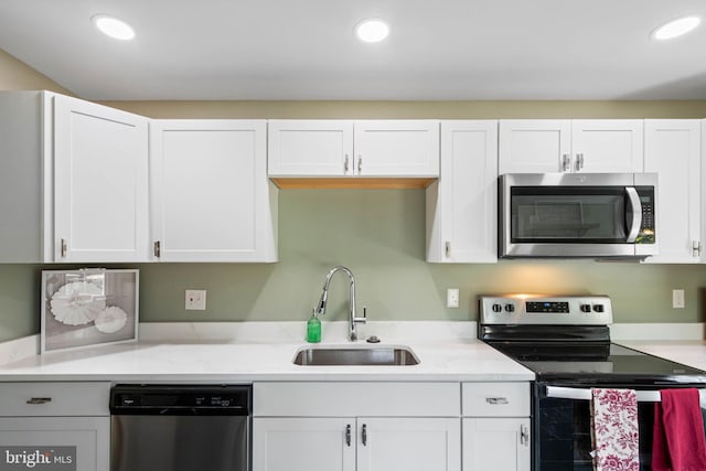 kitchen featuring sink, white cabinets, and stainless steel appliances