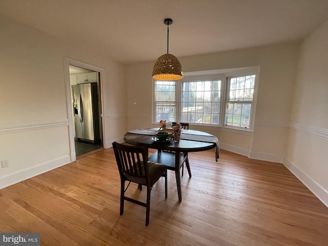 dining space featuring wood-type flooring