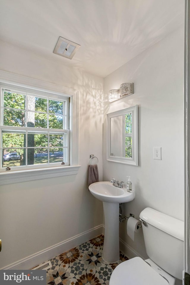 bathroom featuring tile patterned floors, toilet, and sink