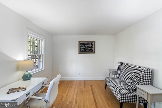 home office with light hardwood / wood-style flooring