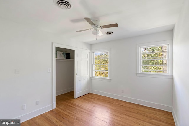 unfurnished bedroom featuring ceiling fan, a closet, and light hardwood / wood-style floors