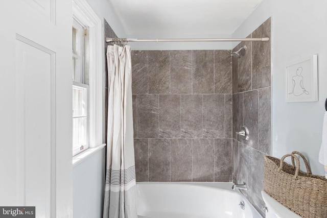 bathroom with shower / tub combo with curtain