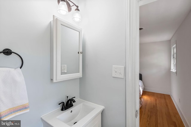 bathroom with hardwood / wood-style floors and sink