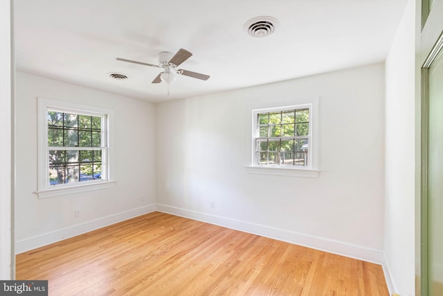 empty room with light hardwood / wood-style floors and ceiling fan