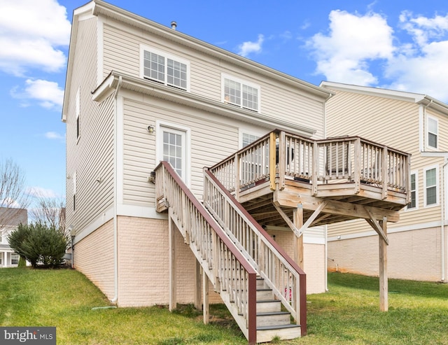 rear view of house with a lawn and a deck