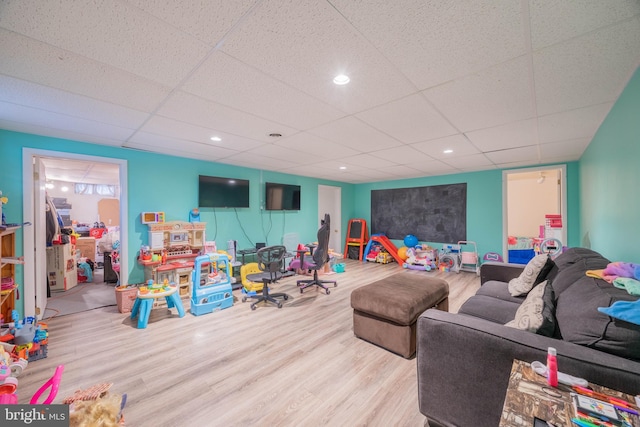 rec room featuring a paneled ceiling and light hardwood / wood-style floors