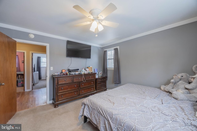 bedroom featuring ceiling fan, ornamental molding, and light colored carpet