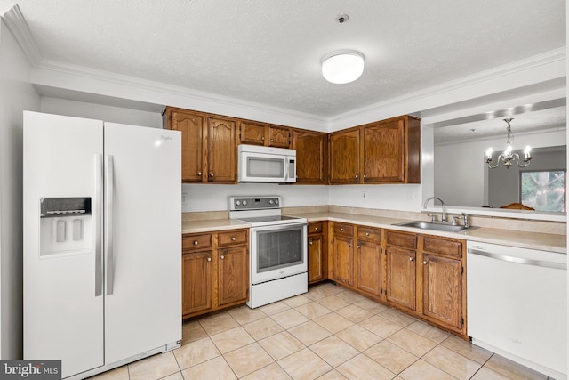 kitchen with pendant lighting, white appliances, an inviting chandelier, sink, and light tile patterned floors