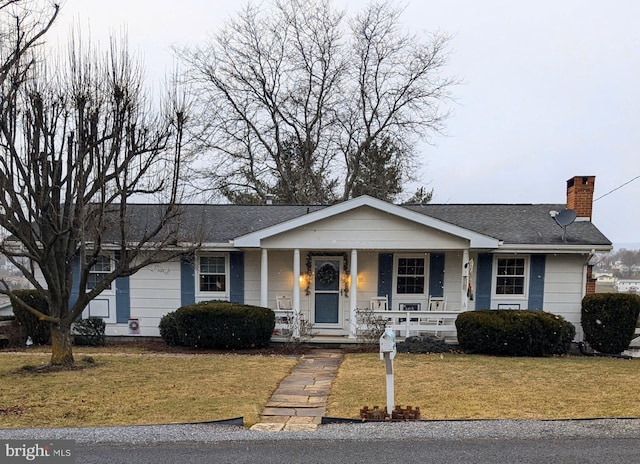 ranch-style house featuring a front yard and a porch