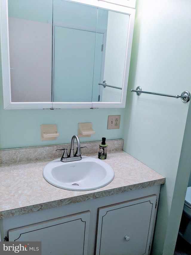 bathroom featuring toilet and vanity