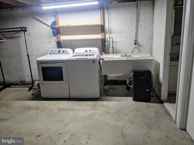 laundry area featuring washing machine and clothes dryer and sink