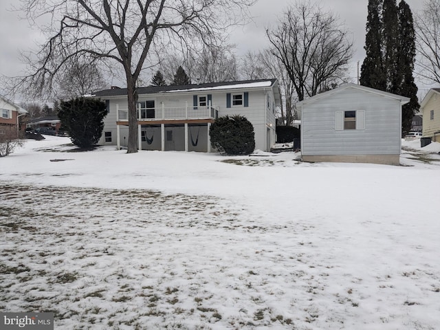 view of snow covered back of property