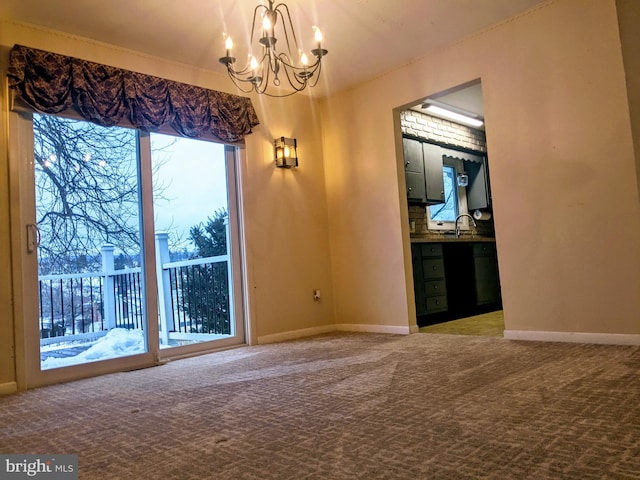 empty room featuring a notable chandelier, sink, and carpet flooring