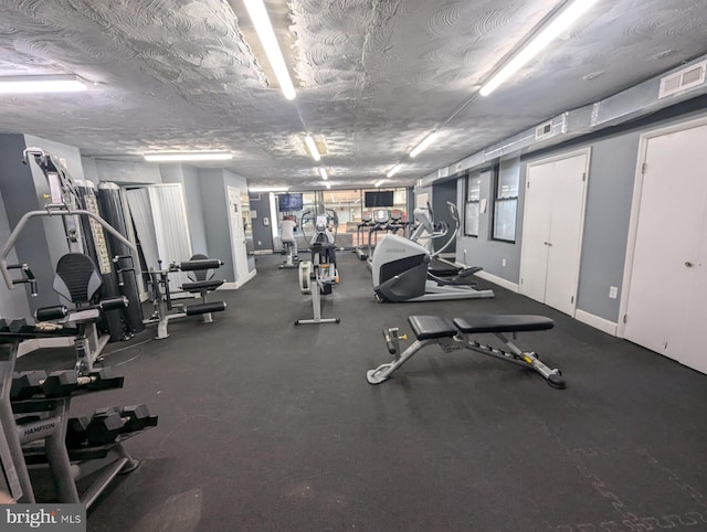 gym featuring a textured ceiling