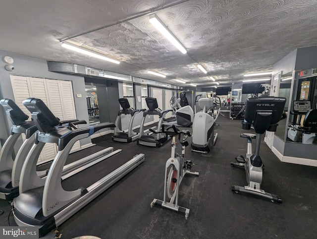 gym featuring a textured ceiling