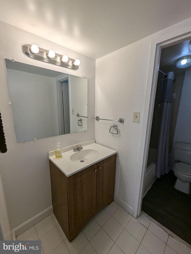 bathroom with tile patterned flooring, vanity, and toilet