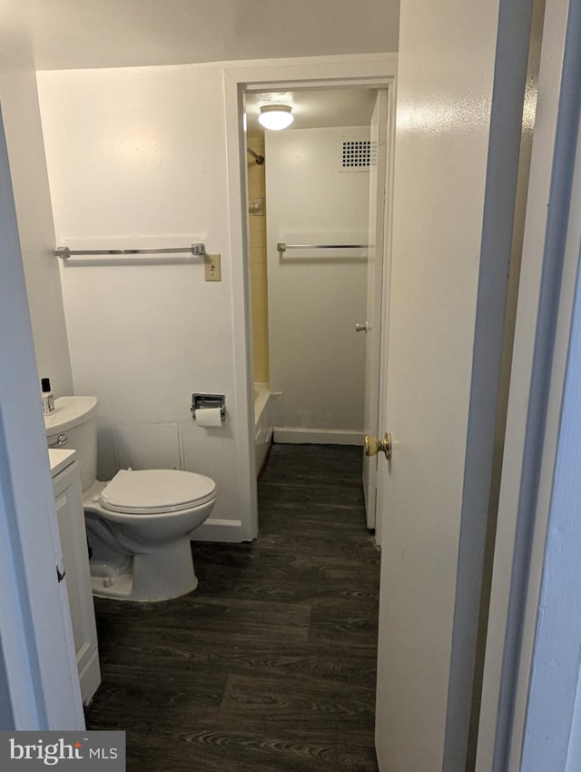 bathroom featuring vanity, toilet, and wood-type flooring