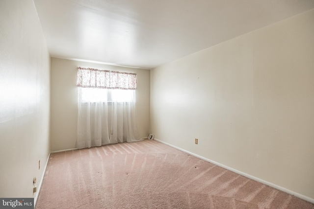 unfurnished room with light colored carpet