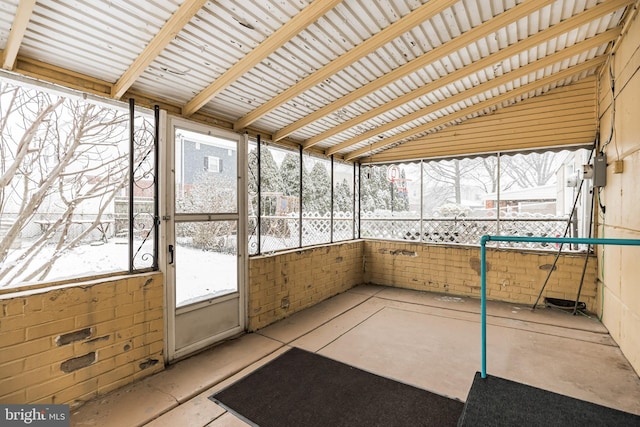 unfurnished sunroom with lofted ceiling