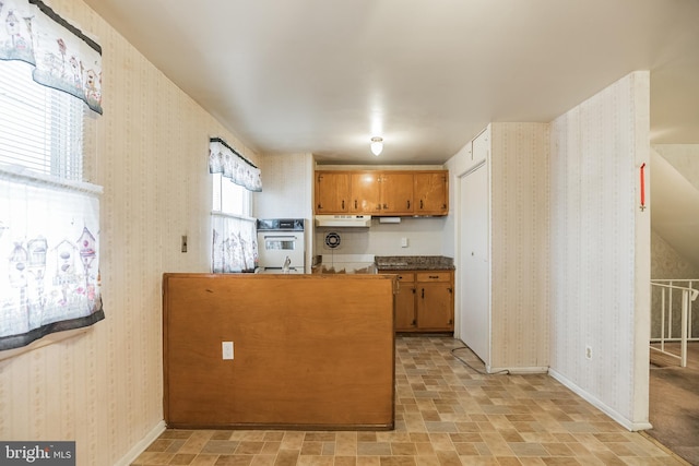 kitchen featuring kitchen peninsula and oven