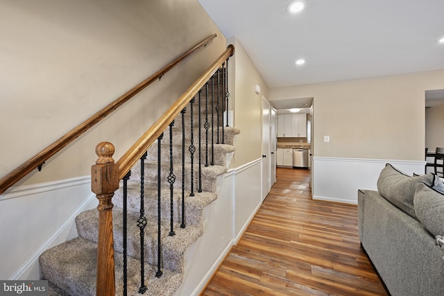 stairs with hardwood / wood-style flooring