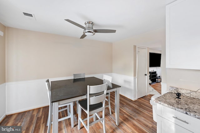 dining room featuring ceiling fan and dark hardwood / wood-style flooring