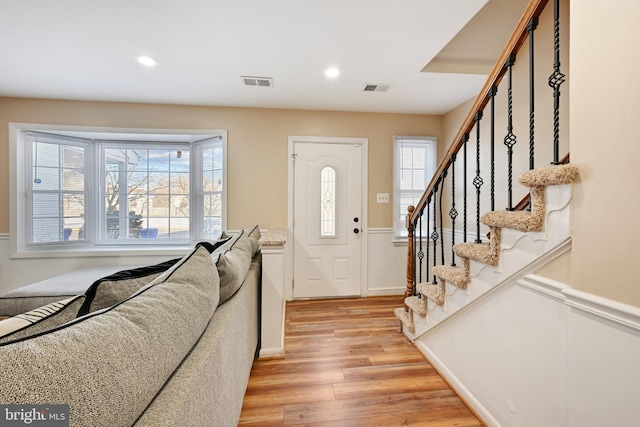 foyer entrance with light hardwood / wood-style flooring and a healthy amount of sunlight