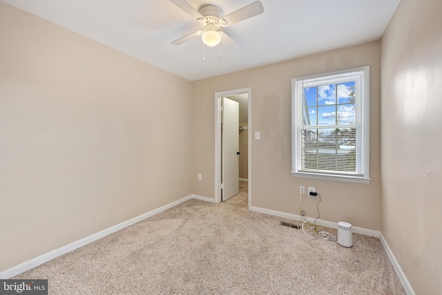 spare room featuring ceiling fan and light carpet